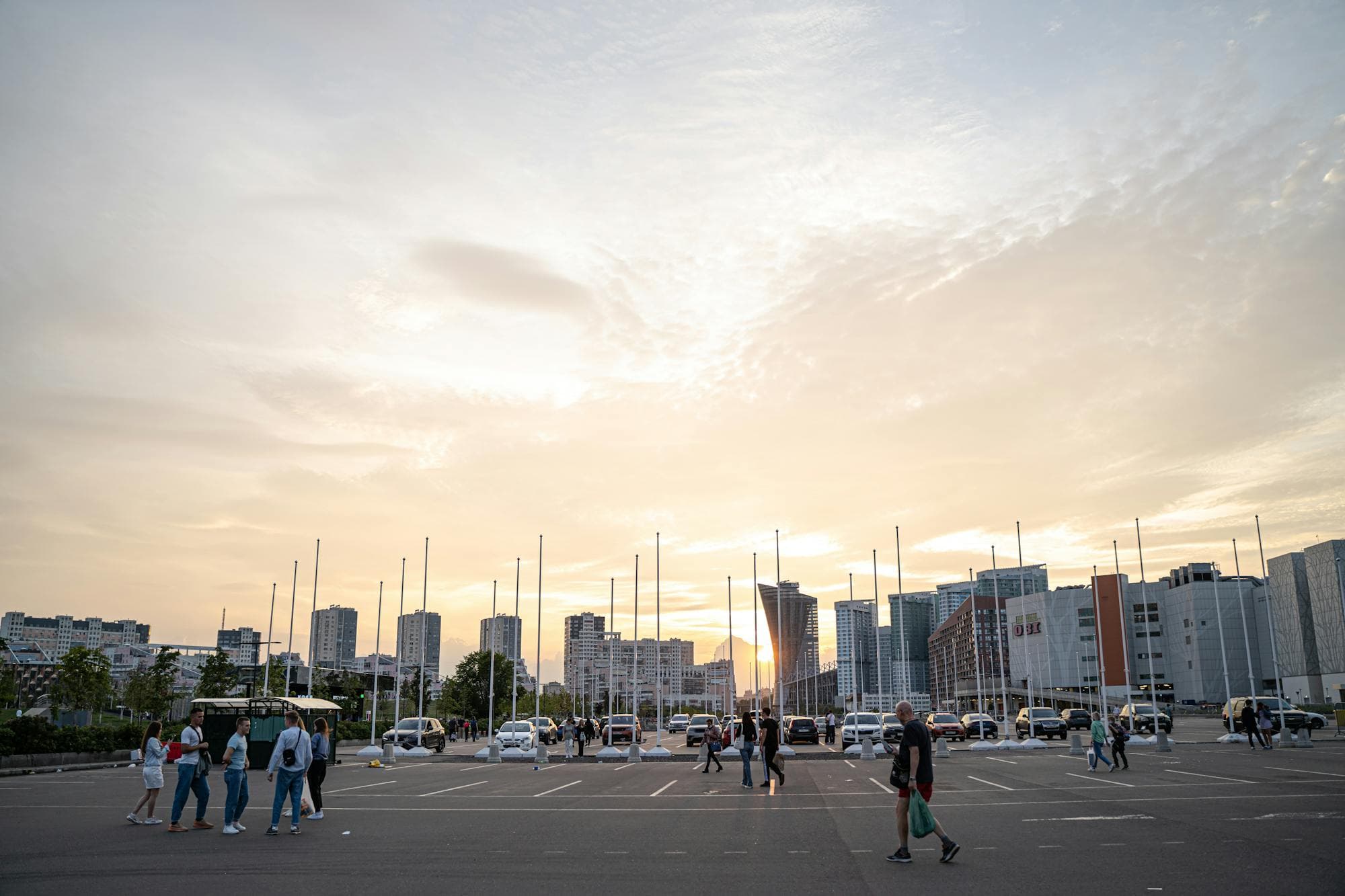People walking through a busy city at sunset